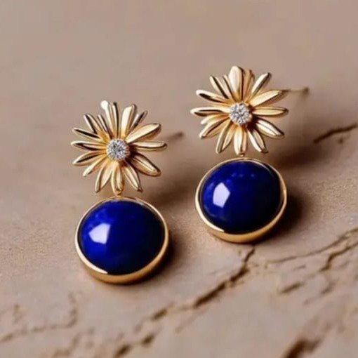 lapis lazuli gold drop earrings on plain background